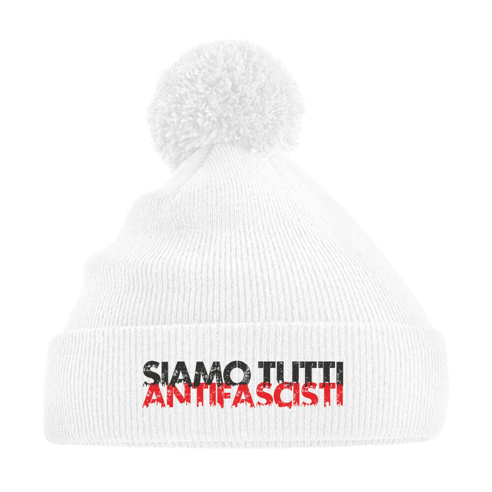 Weiße Strickmütze mit Bommel und dem Aufdruck „Siamo tutti antifascisti“ in Schwarz-Rot – antifaschistisches Winteraccessoire