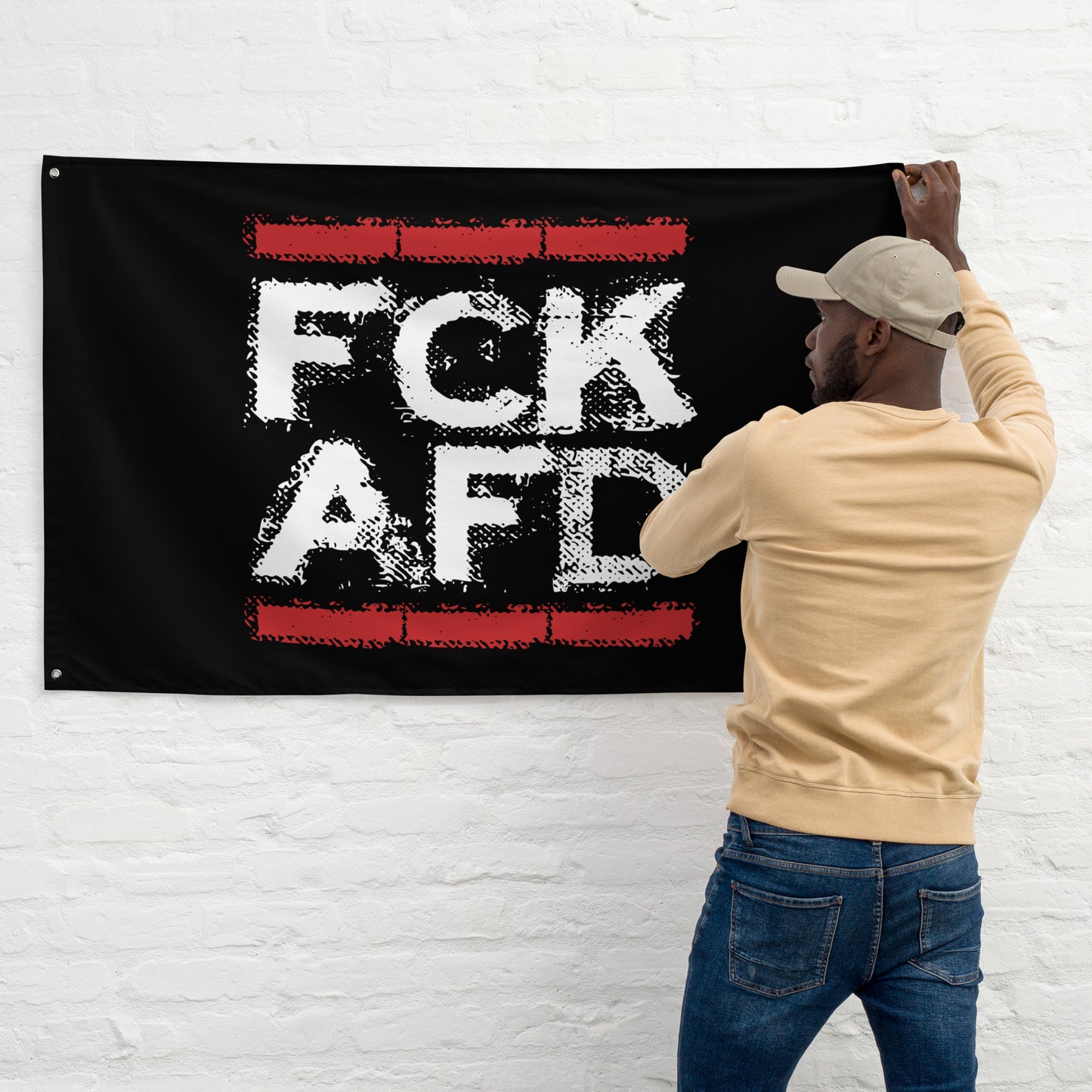 
„Roter Backsteinrahmen und weiß-roter Schriftzug ‚FCK AFD‘ – visuelles Statement gegen Rechtsruck“
